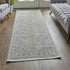 7' X 10' Silver Taupe and Blue Oriental Power Loom Worn Faded Area Rug With Fringe